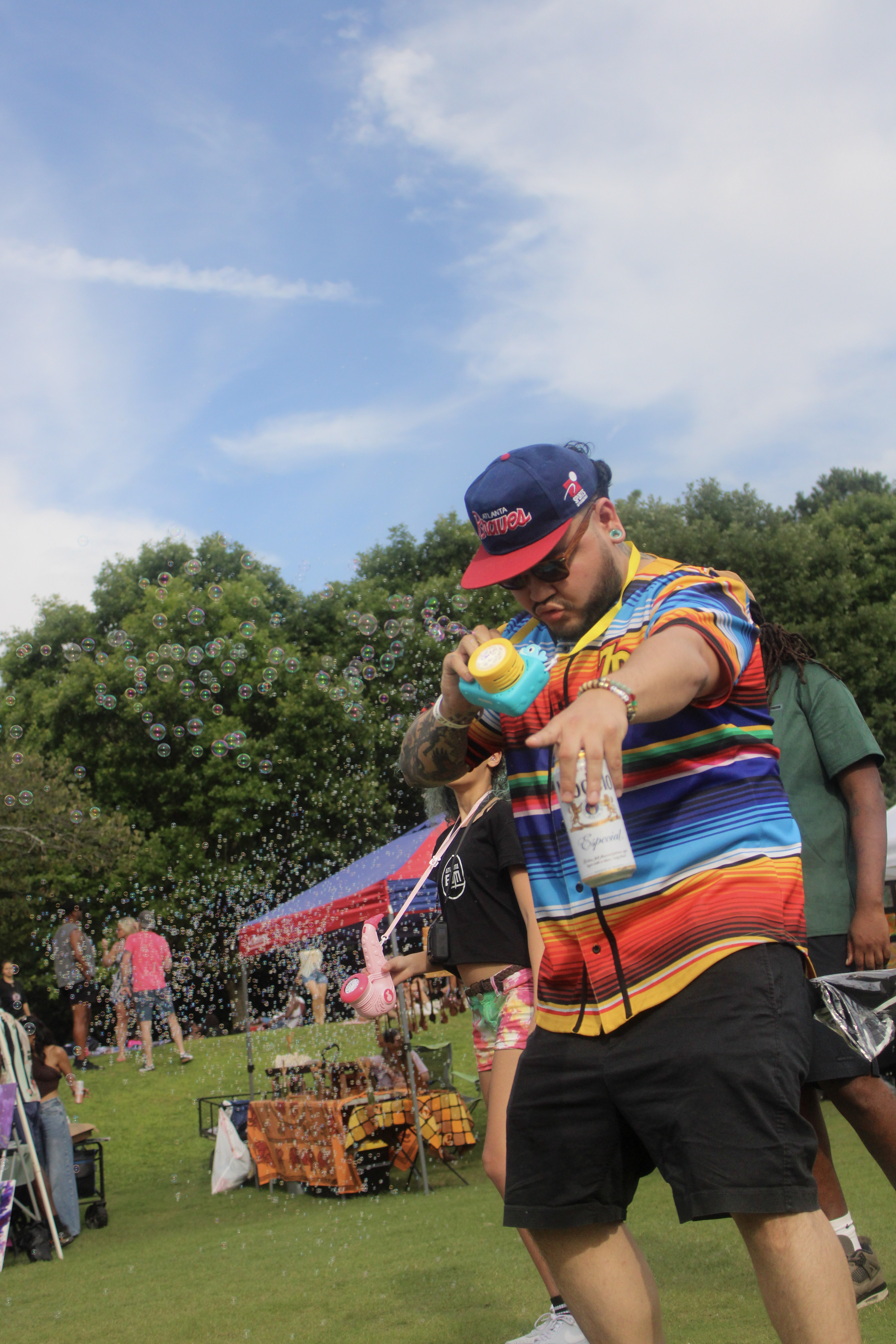 Man in colorful shirt blowing bubbles