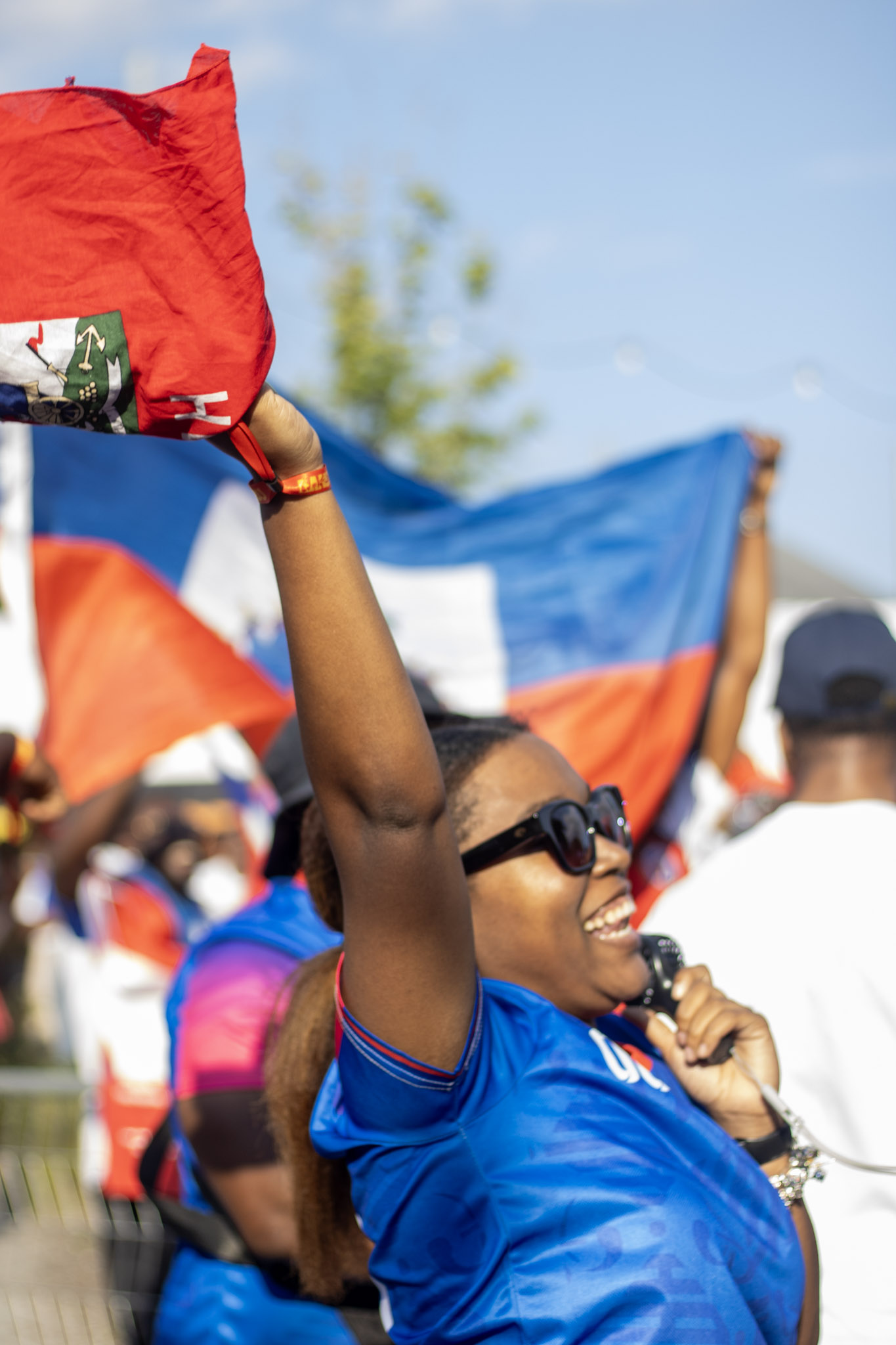woman cheering with haitian flag