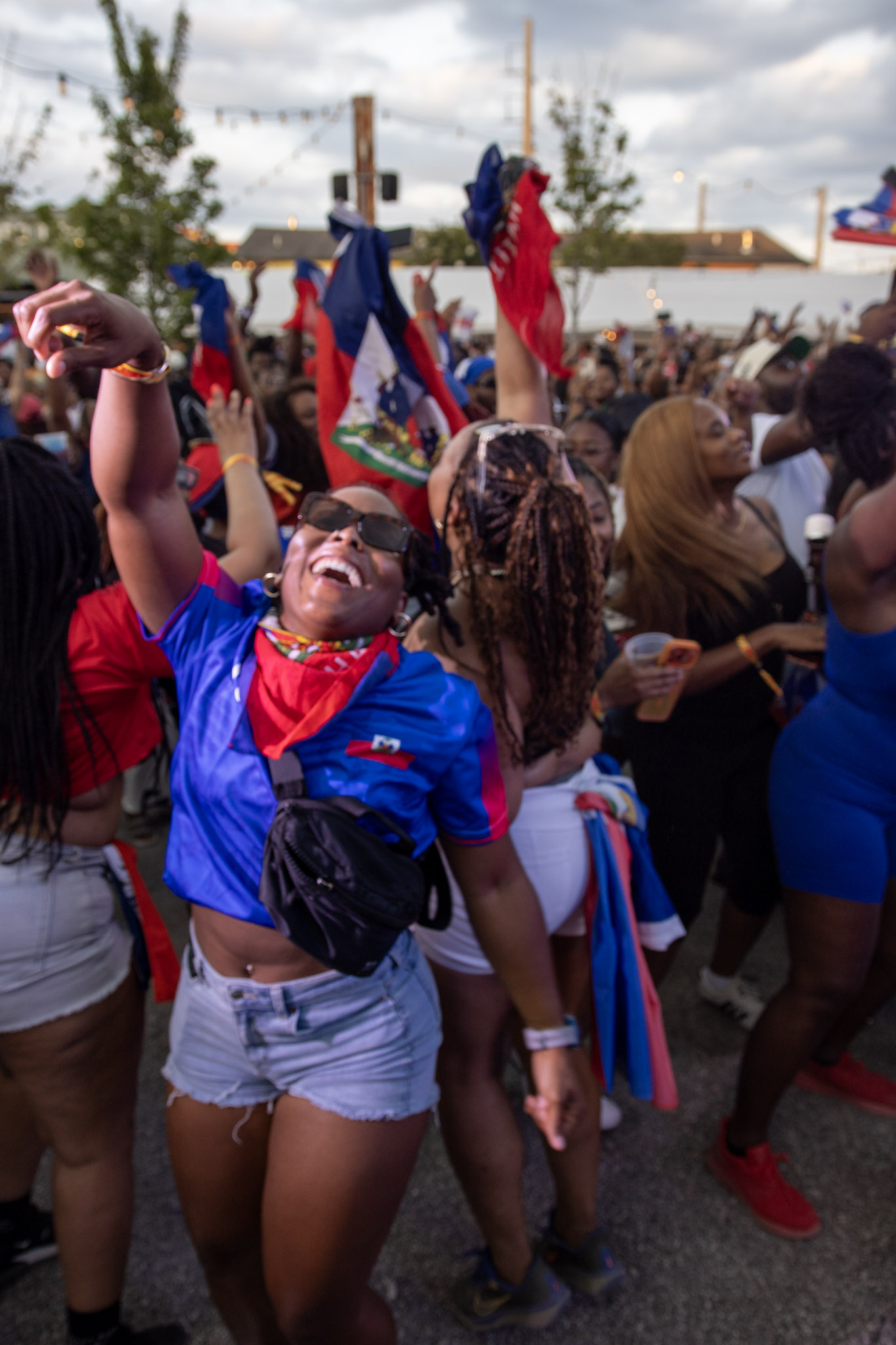 Woman cheering in a crowd of people